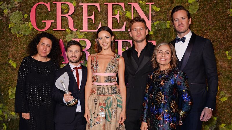 Sara Maino, Gilberto Calzolari, winner of the Franca Sozzani GCC Award for Best Emerging Designer, a model wearing the winning design, Jeremy Irvine, Desiree Bollier, chair Value Retail and Armie Hammer pose backstage at The Green Carpet Fashion Awards in Milan, Italy. Photograph: Dave Benett