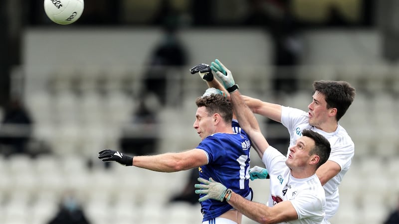 Cavan’s Conor Madden is challenged in the air by Eoin Doyle and Mick O’Grady. Photograph: Laszlo Geczo/Inpho