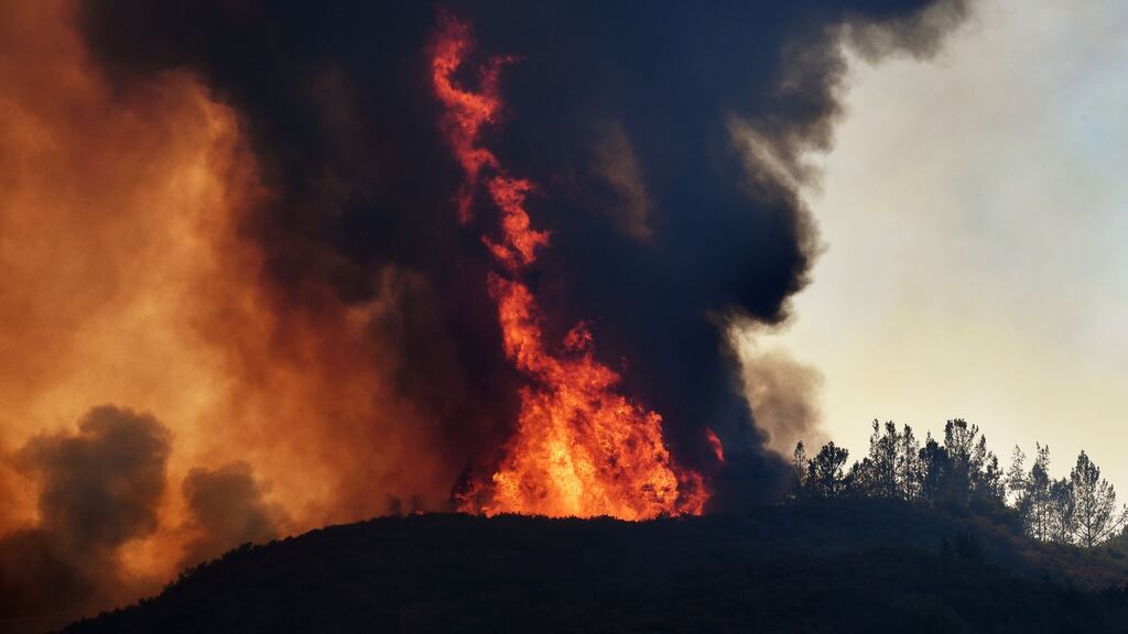 Flames estimated by firefighters to be 200ft to 260ft engulf a ridge near the town of Lakeport, California. Photograph: MARK RALSTON/AFP/Getty Images