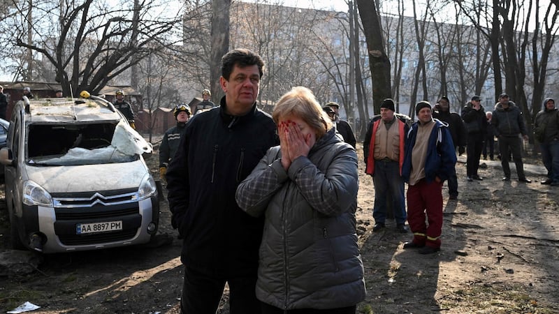 Evacuated residents stand outside their destroyed apartment building in Kyiv. Photograph: Sergei Supinsky/AFP via Getty