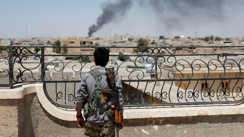 A Kurdish fighter from the People’s Protection Units (YPG) looks at the aftermath of a coalition air strike in Raqqa, Syria. File photograph: Goran Tomasevic/Reuters