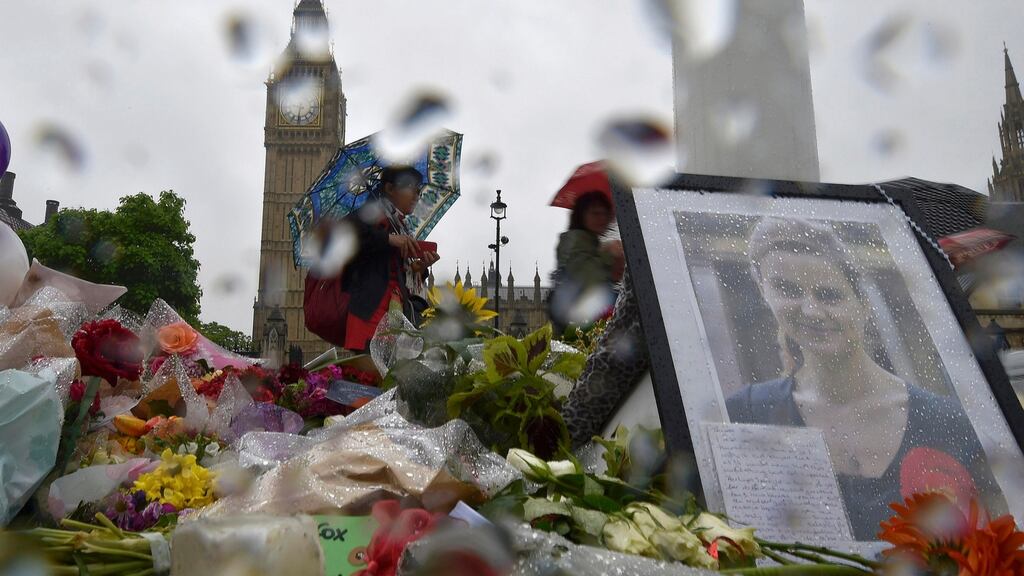 People view tributes in memory of murdered British Labour Party MP Jo Cox, who was shot dead in Birstall, at Parliament Square in London. Reuters/Toby Melville