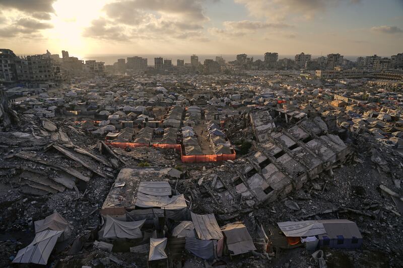 A tent camp for displaced Palestinians stretches among the ruins of buildings destroyed by Israeli bombardments. Photograph: Jehad Alshrafi/AP