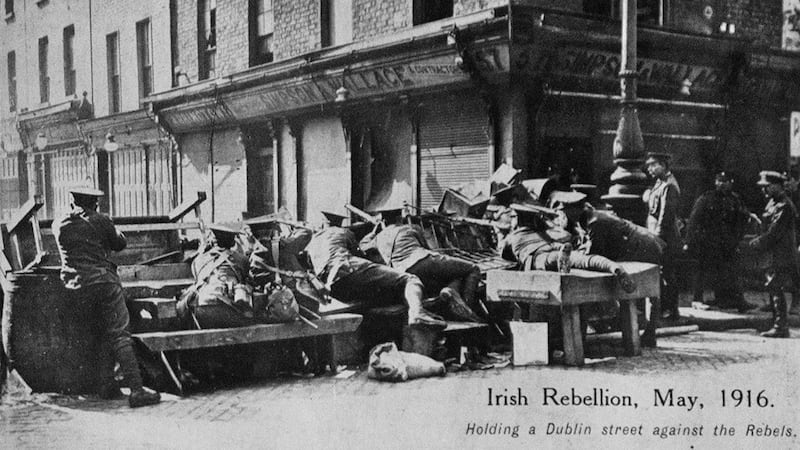 Towards the end of, and also after the Rising, there were many posed photographs showing British troops poised for action. This image shows troops at a barricade at the intersection of Moore and Parnell Streets. Photograph: Allen Library
