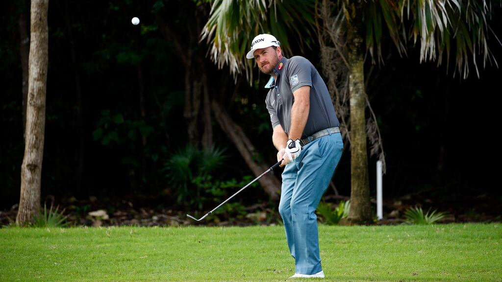 Graeme McDowell hits his third shot on the first hole during the third round of the OHL Classic Photograph: Justin Heiman/Getty Images