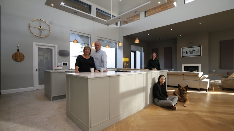 Joyce and Jonathan Kirwan in their kitchen with children Abi and Jenni (right), and dog Bruce. Photograph: Nick Bradshaw/The Irish Times