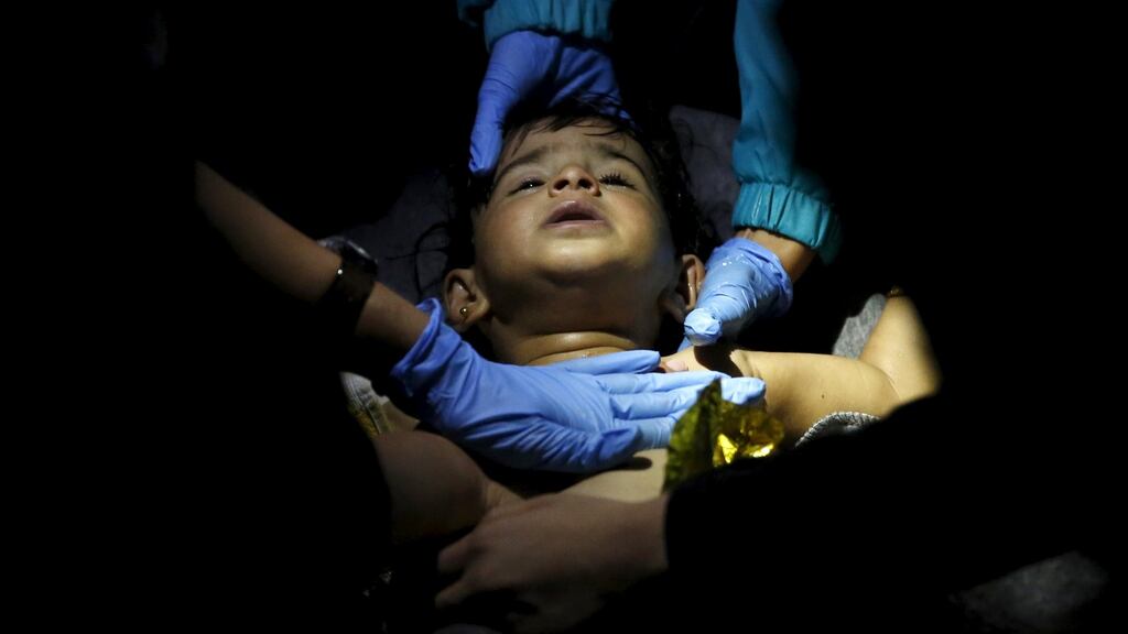 Volunteer doctors and paramedics try to revive a young child on the Greek island of Lesvos after a boat carrying more than 200 refugees and migrants sank while crossing the Aegean sea from Turkey. A search is continuing amid fears that 34 people are unaccounted for. Photograph: Giorgos Moutafis/Reuters