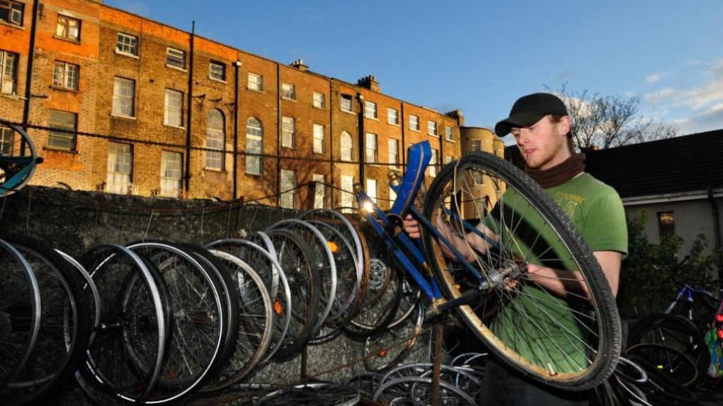 Rob O’Reilly, a bicycle mechanic in Seomra Spraoi off Mountjoy Square in Dublin, fixing a bike for the workshop. Photograph: Aidan Crawley
