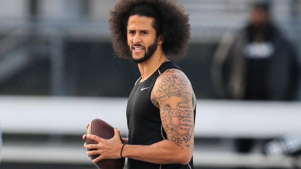 Colin Kaepernick looks to make a pass during a private NFL workout held at Charles R Drew high school in Riverdale, Georgia. Photograph: Carmen Mandato/Getty Images