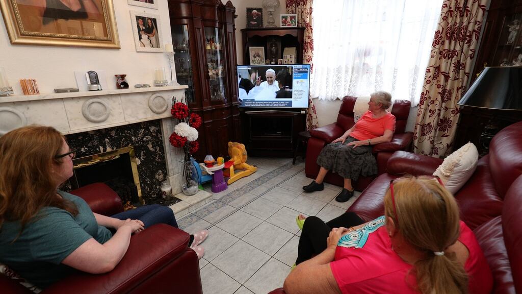 The Dalton and Hutchins family watches Pope Francis visit on TV along Church Terrace, Dublin. Photograph: Aaron Chown/PA Wire