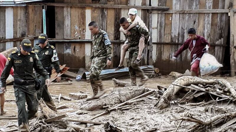 Handout picture released by the Colombian Army press office showing soldiers helping to evacuate locals following mudslides caused by heavy rains, in Mocoa, Putumayo department, on Saturday. Photograph: AFP/Getty Images.
