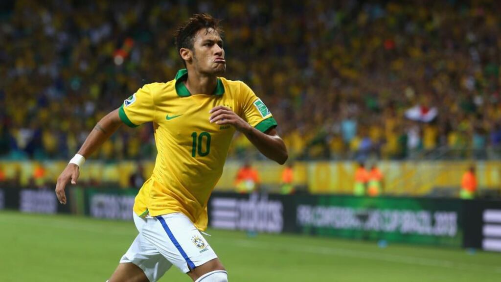 Brazil’s Neymar celebrates a wonder free kick against Italy.