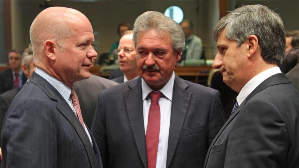 British foreign secretary William Hague, left, talks with Luxembourg’s foreign minister Jean Asselborn, centre, and Austrian foreign minister Michael Spindelegger during the EU foreign ministers meeting on Monday. (AP Photo/Yves Logghe)