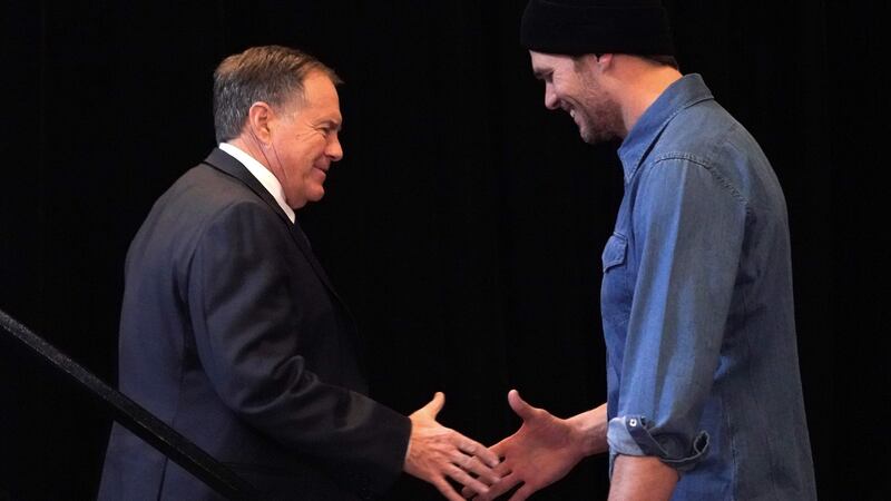 New England Patriots quarterback Tom Brady greets head coach Bill Belichick at a media event in Atlanta. Photograph: Timothy A Clary/AFP/Getty Images