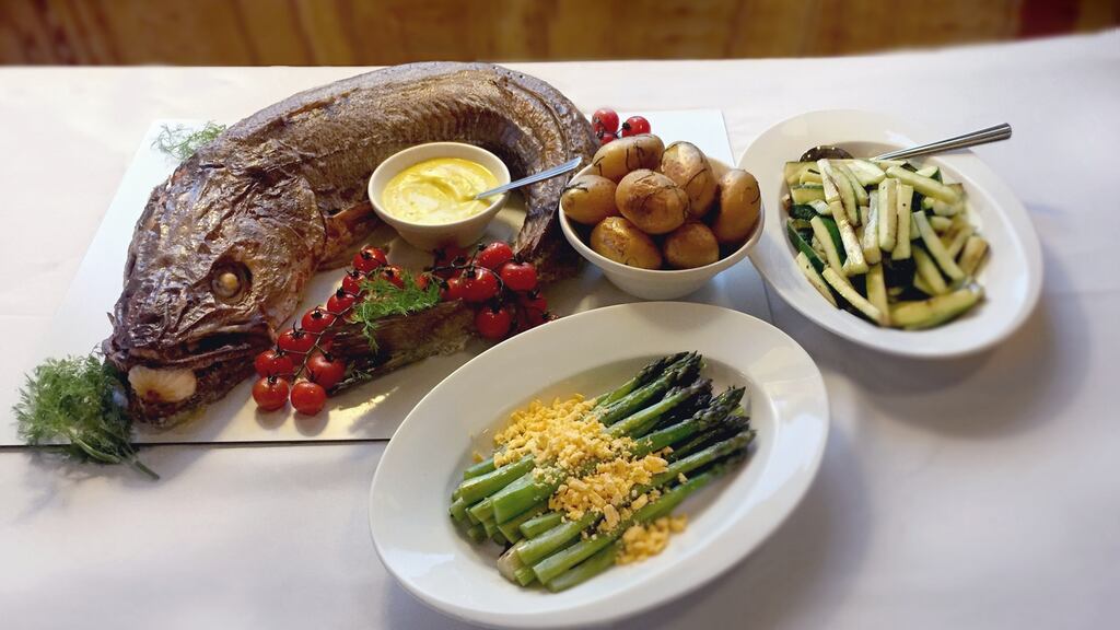 Roasted whole hake with minted baby potatoes, asparagus mimosa, courgette batons and Hollandaise sauce