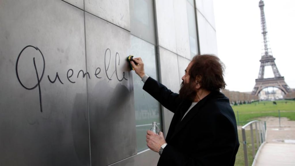 French author Marek Halter cleans the word ‘quenelle’ written on “The Wall For Peace” at the Champs de Mars near the Eiffel Tower in Paris on Monday. Photograph: Reuters