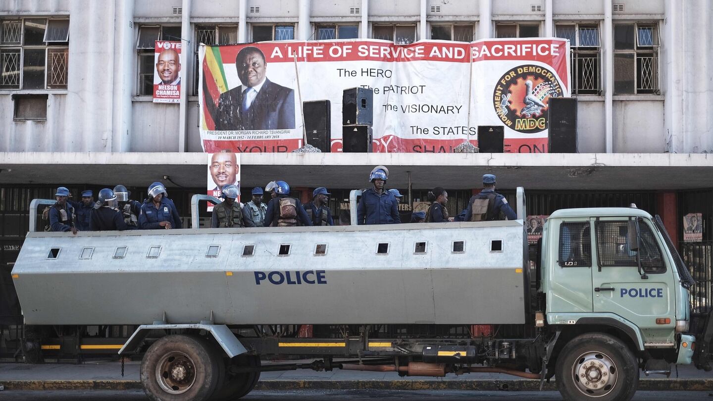 Zimbabwean riot police officers stand guard in front of the headquarters of the opposition party Movement for Democratic Change on Thursday in Harare. Photograph: Marco Longari/AFP/Getty Images