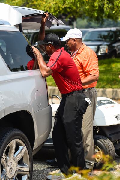 Woods suffers a back spasm as he gets into his car after withdrawing from the 2014 event. Photo: Chris Condon/PGA Tour
