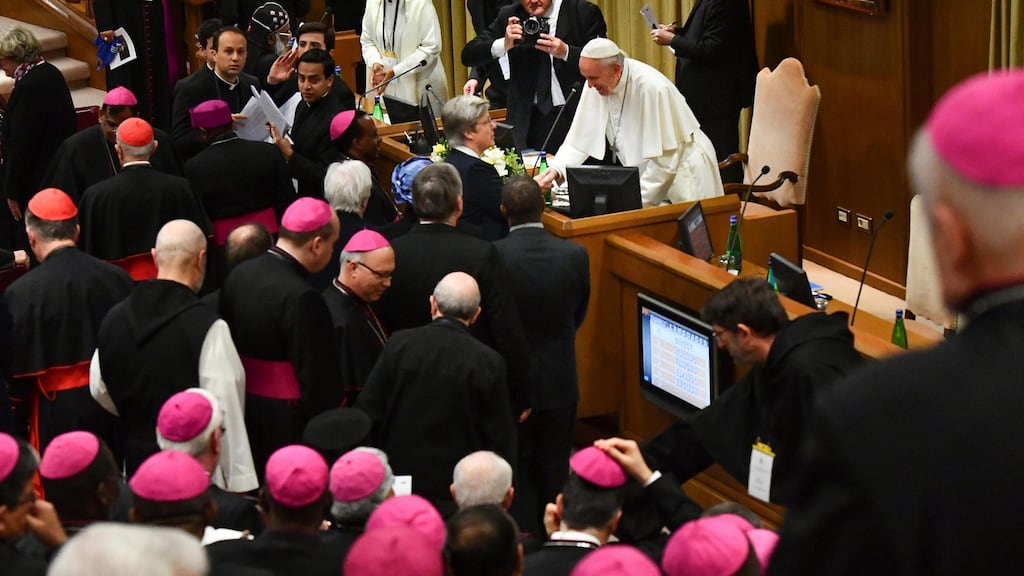 Pope Francis greets clergymen at the opening of a global child protection summit. Photograph: Vicenzo Pinto/AFP