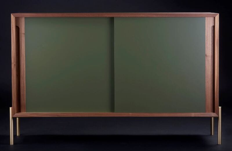 A privately commissioned walnut sideboard with sage green sliding doors from David Oliver Bespoke.