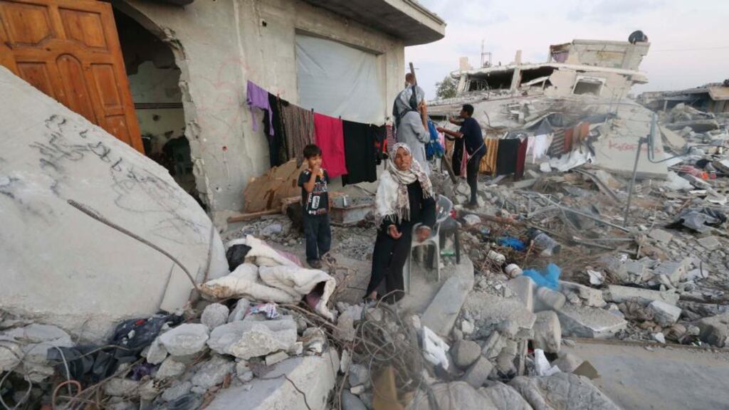 A Palestinian woman sits outside her house that witnesses said was destroyed during the seven-week Israeli offensive in the southern of Gaza Strip. Photograph: Ibraheem Abu Mustafa/Reuters