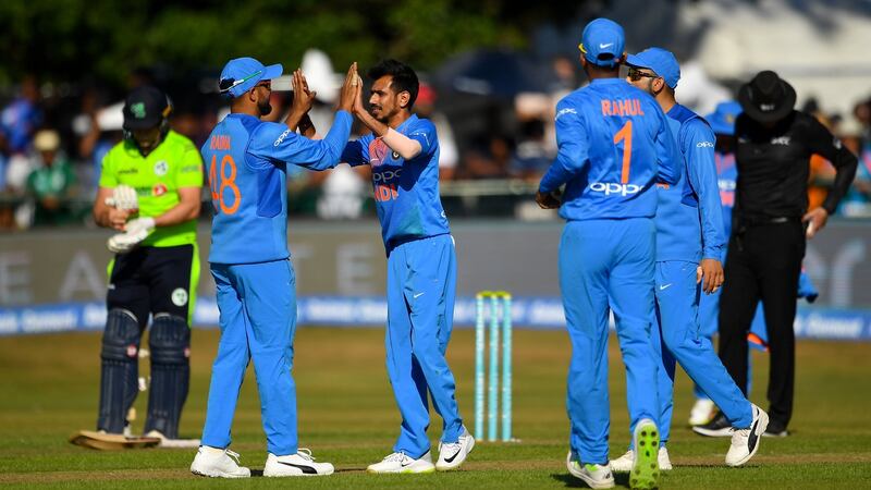 Yuzvendra Chahal (c) is congratulated by Suresh Raina after bowling out Andrew Balbirnie. Photograph: Seb Daly/Sportsfile