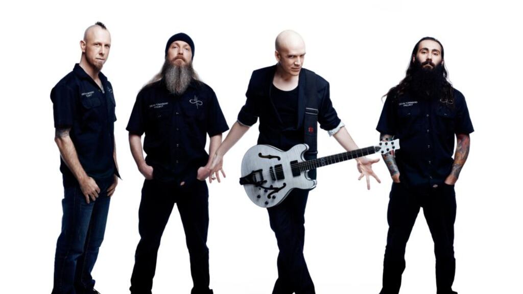 Bald headed: Devin Townsend (with guitar) is noted for his full-on commitment to his art on and off stage.