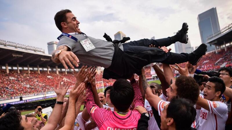 Chinese Super League: Tianjin Quanjian players celebrate their win against Guangzhou Evergrande with their head coach, Fabio Cannavaro on November 4th. Five days later he was announced as Guangzhou’s new manager. Photograph: AFP/Getty