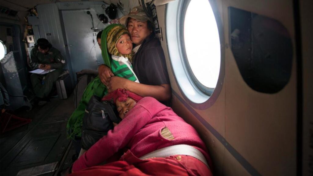 A man holds his son and mother in an Indian army helicopter after being rescued from Ramechhap district in Nepal yesterday. Photograph: Hemanta Shrestha/EPA