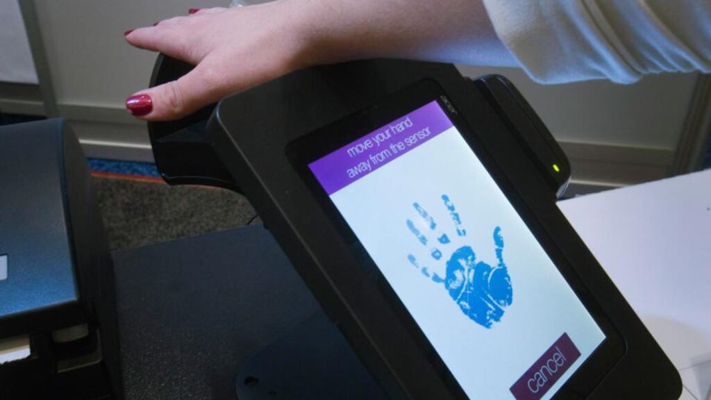 A woman registers her palm on a PulseWallet, a point-of-purchase device, during the 2014 International Consumer Electronics Show (CES) in Las Vegas earlier this month. Photograph: Steve Marcus/Reuters