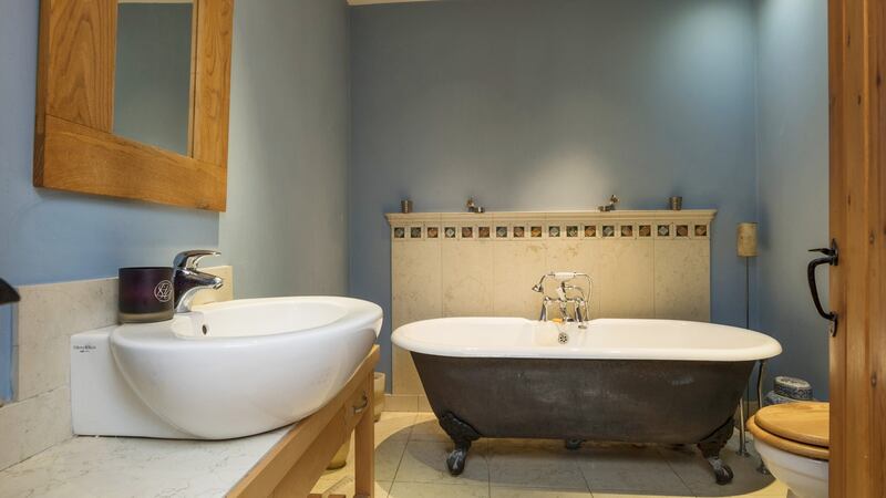 The bathroom is stylishly finished with an antique claw-foot bath and contemporary Villeroy & Boch sink