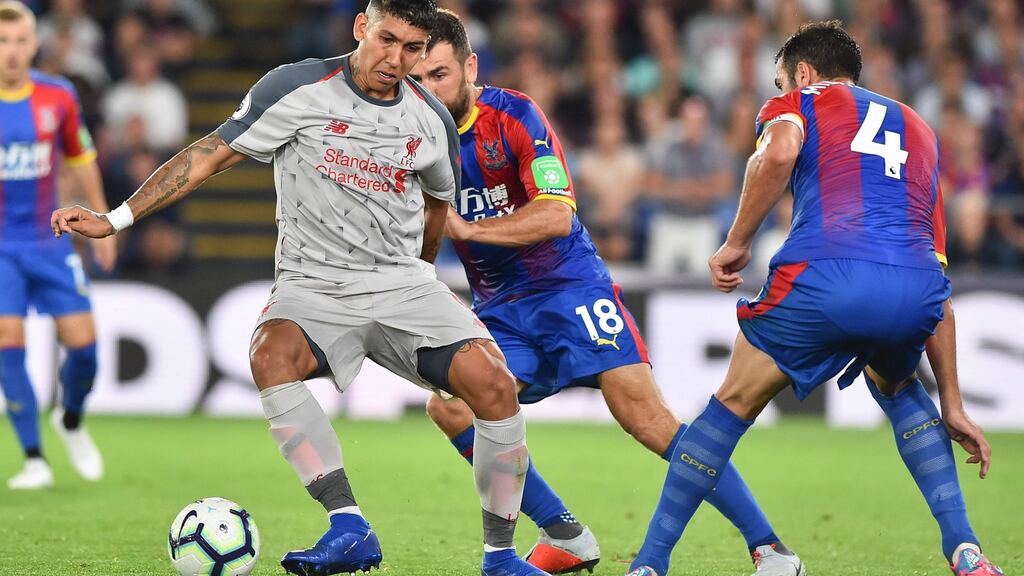 Liverpool’s Roberto Firmino in action against  Crystal Palace   midfielder James McArthur during the Premier League clash at Selhurst Park.   GlynKirk/AFP