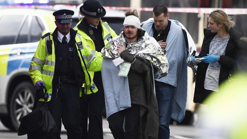 A member of the public is treated by emergency services near Westminster Bridge and the Houses of Parliament on March 22th in London. Photograph: Carl Court/Getty Images