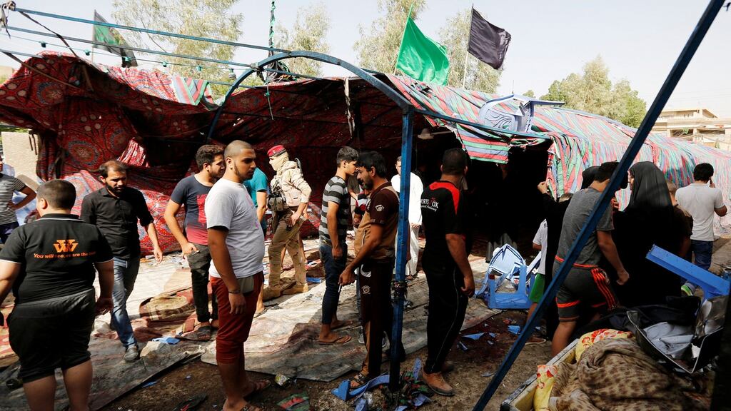 People gather at the site of a suicide bomb attack in Baghdad’s northern al-Shaab district on Saturday. Photograph: Reuters
