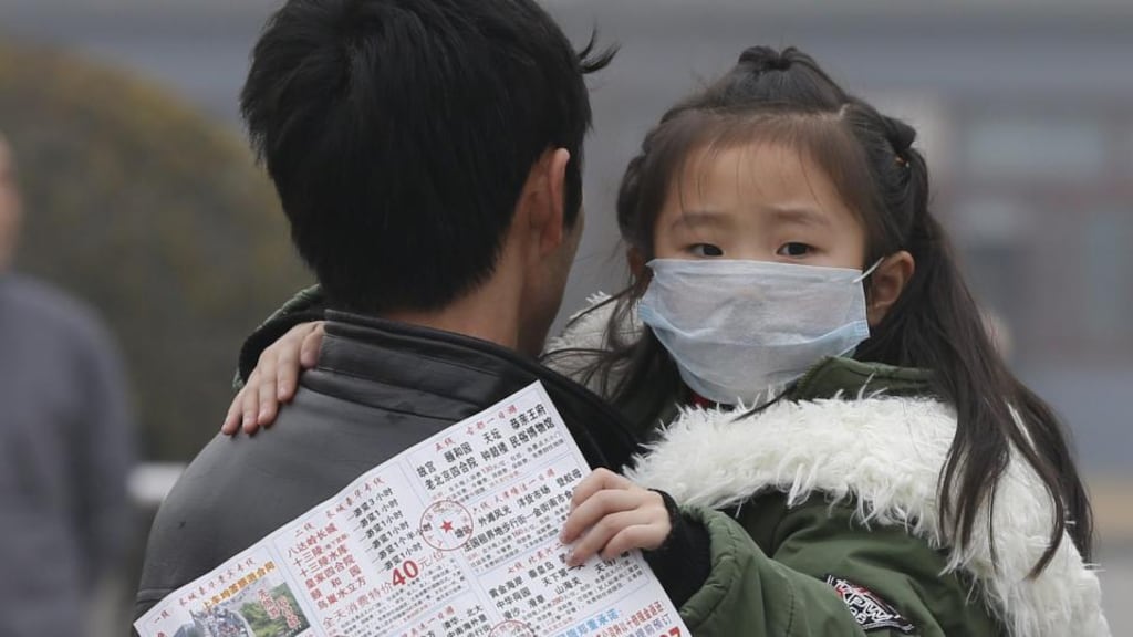 A child wearing a protective mask in Tiananmen Square, Beijing. Beijing’s mayor Wang Hansen has said smog had made the capital “unlivable”. Photograph: EPA