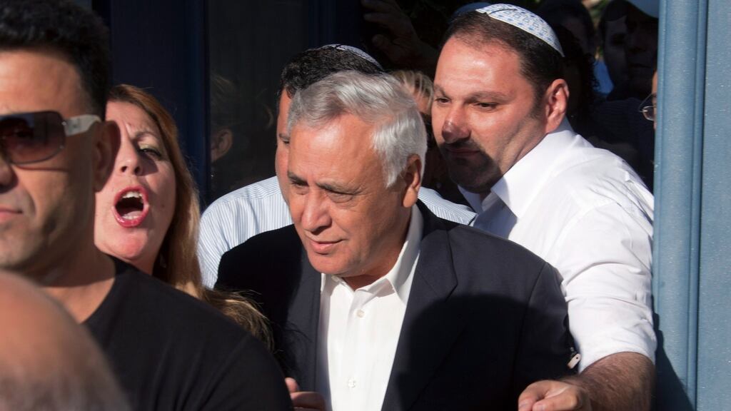 Former Israeli president Moshe Katsav (centre)on his way to prison in 2011. Photograph: Jim Hollander/EPA