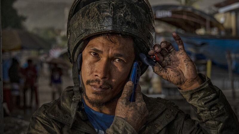 A resident covered in ash mixed with rainwater after Taal Volcano began spewing ash up to a kilometre high into the air. Photograph: Ezra Acayan/Getty Images