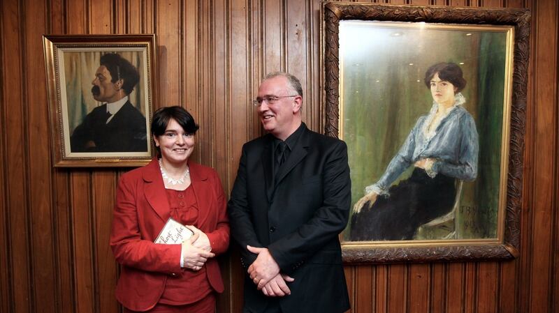 Ghost Light author Joseph O’Connor at the Abbey Theatre, Dublin with his sister Sinead, with portaits in the background of JM Synge and Molly Allgood. Photograph: Jason Clarke Photography