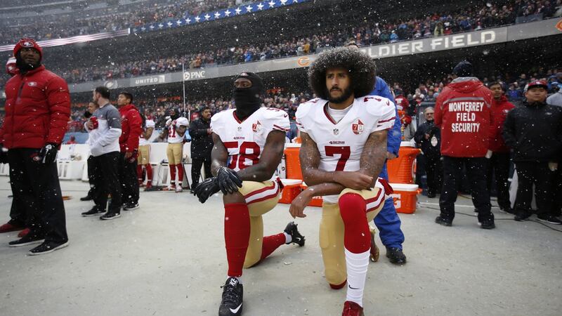 Eli Harold and Colin Kaepernick of the San Francisco 49ers kneel on the sideline during the anthem. Photograph: Michael Zagaris/San Francisco 49ers/Getty Images