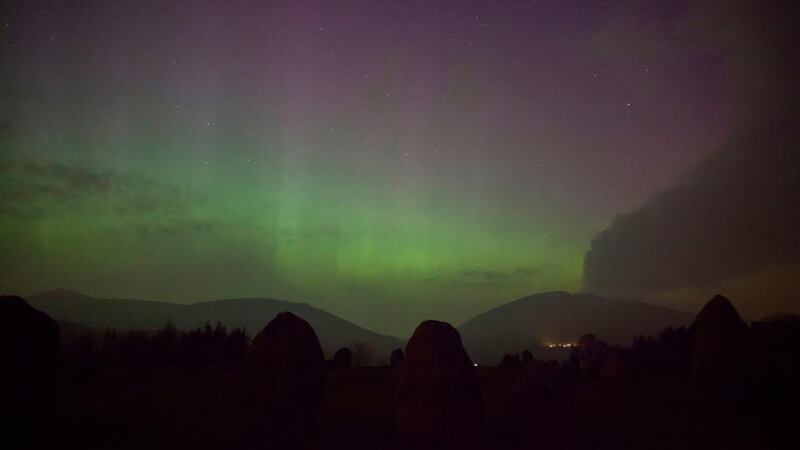 The aurora borealis, or the northern lights as they are commonly known, at Castlerigg Stone Circle in the Lake District, with Blencathra and Skiddaw behind. Photograph: Tom White/PA Wire