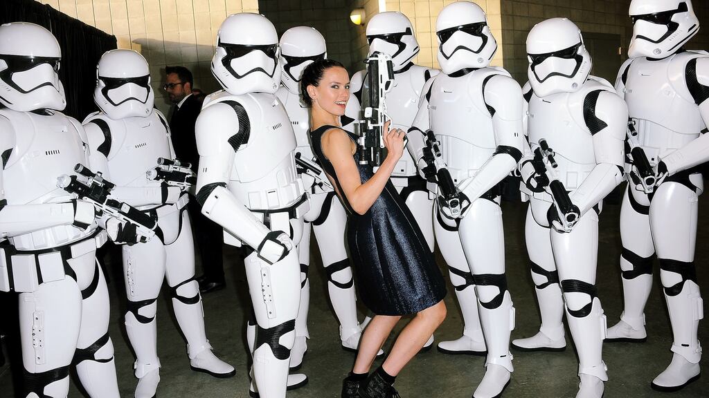 Daisy Ridley poses with Stormtroopers backstage at the Lucasfilm panel during Comic-Con International 2015 at the San Diego Convention Center on July 10, 2015 in San Diego, California. (Photo by Albert L. Ortega/Getty Images)