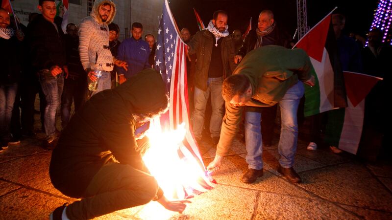 Palestinian protesters burn the US flag in Bethlehem’s Manger Square. Photograph: Musa Al Shaermusa Al Shaer/AFP/Getty Images