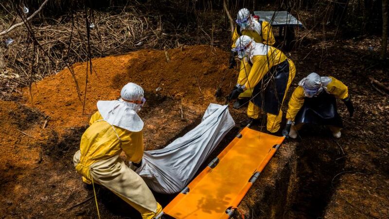 Grave: a body is buried next to an Ebola treatment unit in Liberia. Photograph: Daniel Berehulak/New York Times
