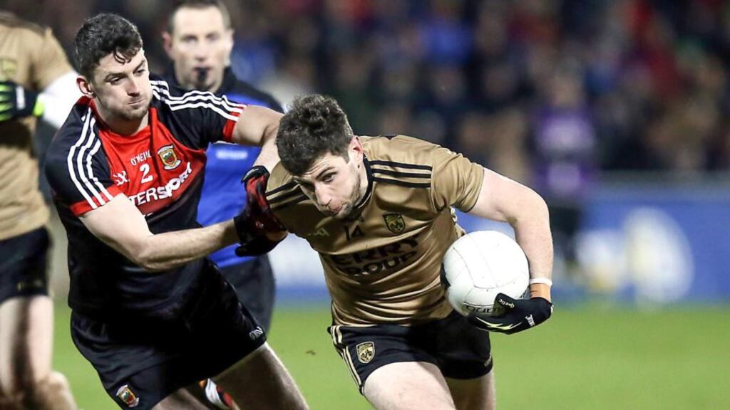 Mayo’s Brendan Harrison attempts to get to grips with Kerry’s Paul Geaney on Saturday night in McHale Park. Photograph: Inpho/John McVitty