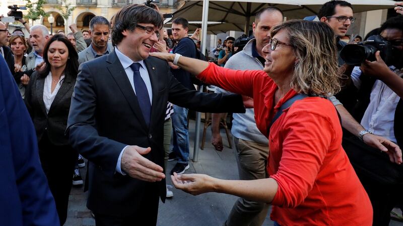 Sacked Catalan president Carles Puigdemont greets a supporter in Girona, Spain. Photograph: Rafael Marchante/Reuters