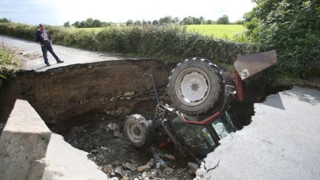 An overturned tractor after a road collapsed in Iskaheen, Co Donegal. Photograph: Niall Carson/PA Wire