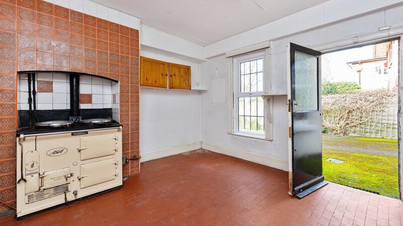 The kitchen and its cream four-door Aga and side door entrance.