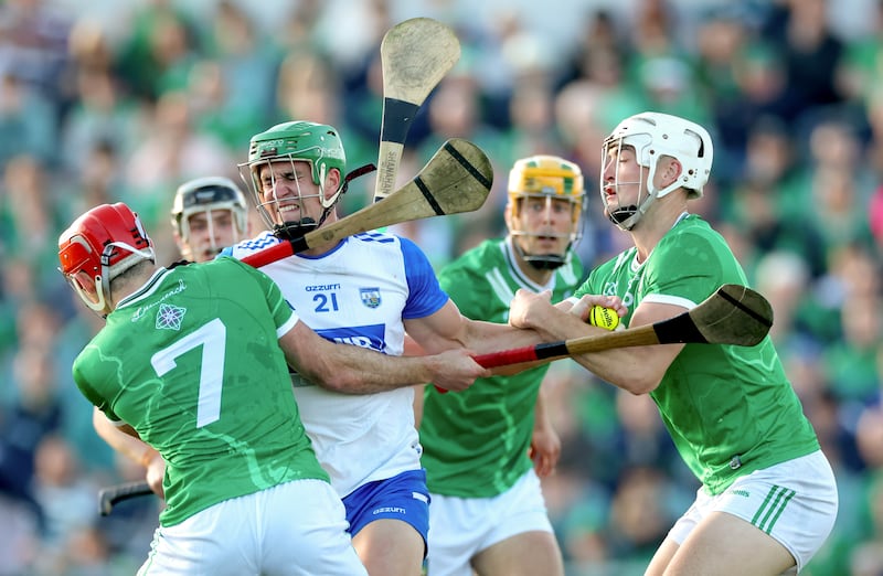Waterford’s Michael Kiely is tackled by Barry Nash and Kyle Hayes of Limerick. Photograph: James Crombie/Inpho