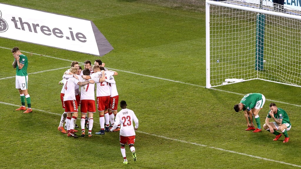 Denmark players celebrate after their playoff triumph. Photograph: Gary Carr/Inpho