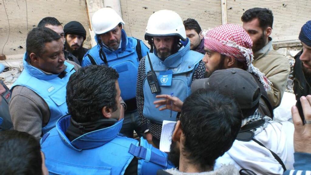 UN members talk with Sheikh Abu Harith al-Khalidi (right), who is in charge of negotiations for civilians inside the besieged area of Homs yesterday. Photograph: Reuters